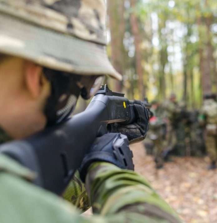 soldier aiming gun at target